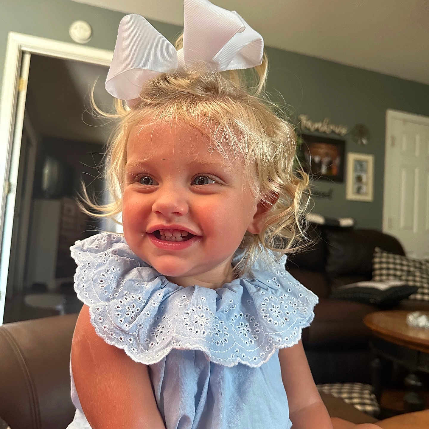 Emerson is registered to the contest to win money with this photo: architecture, art, baby, babylaughing, blonde, building, couch, cushion, face, furniture, hair, happy, head, homedecor, indoors, painting, person, photography, portrait, smile