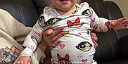 Dakota joined the competition — help win amazing prizes! accessories, baby, bodypart, clothing, couch, cushion, face, finger, furniture, hand, happy, head, homedecor, jewelry, pajamas, person, photography, portrait, ring, wristwatch