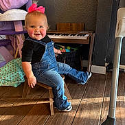 Dakota joined the competition — help win amazing prizes! accessories, baby, clothing, couch, face, footwear, furniture, hardwood, head, jeans, keyboard, musicalinstrument, pants, person, photography, piano, portrait, shoe, sitting, wood
