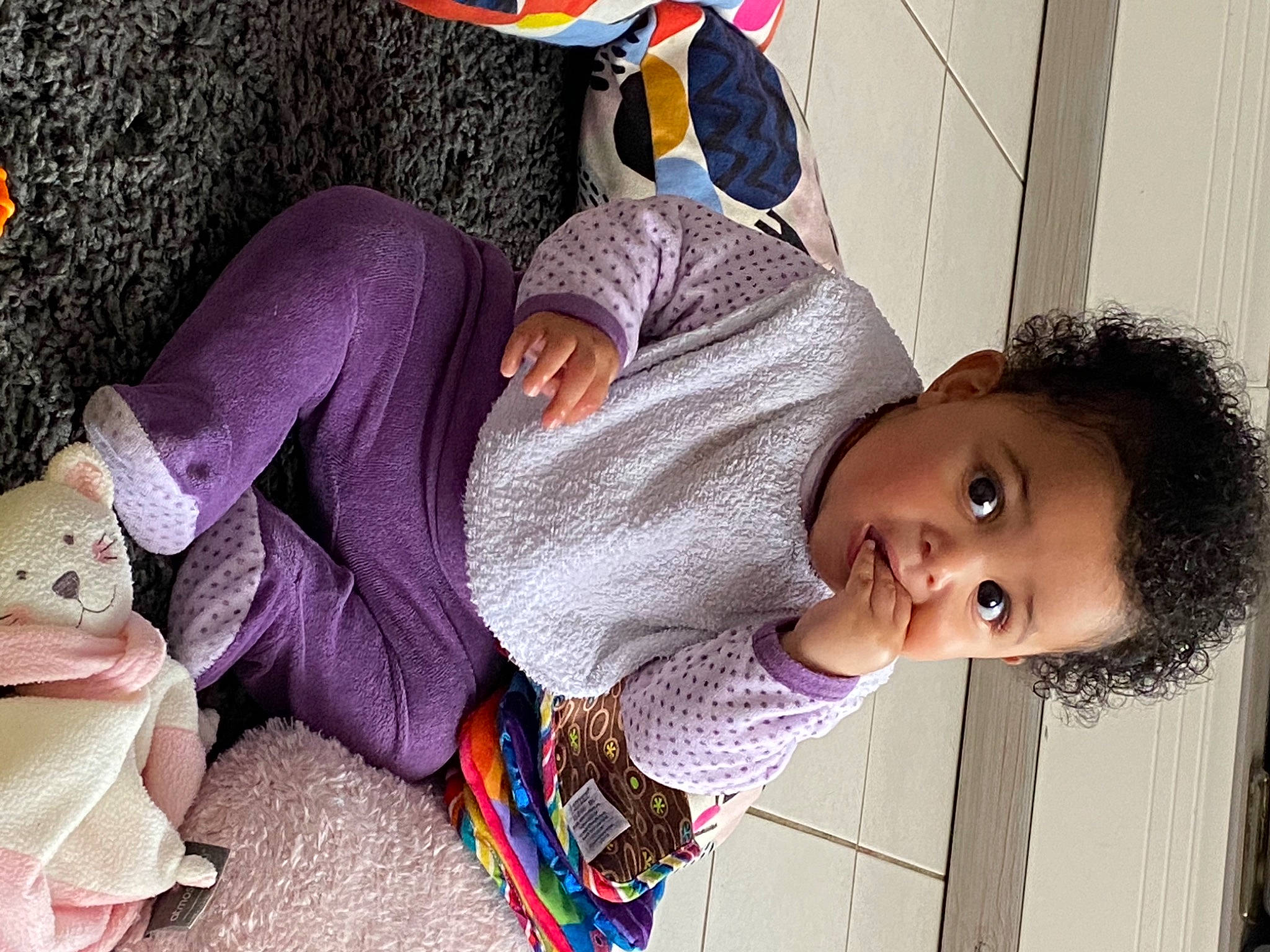 Aliyah participe au concours pour gagner de l'argent avec cette photo : arm, baby, baby_toddler_clothing, child, clothing, comfort, fun, happy, human, human_body, joint, linens, pattern, person, purple, sitting, skin, surprise, toddler, tree