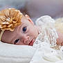 baby, infant, newborn, headband, flower_headband, blue_eyes, lace, blanket, soft_toy, stuffed_animal, portrait, closeup, soft_lighting, bokeh, lying_down, tulle, cute, face, gaze, innocence