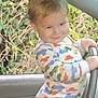 toddler, child, car, steering_wheel, pajamas, smile, indoors, window, greenery, leaves, seat, clothing, person, cute, playful, portrait, baby, fun, vehicle, hand