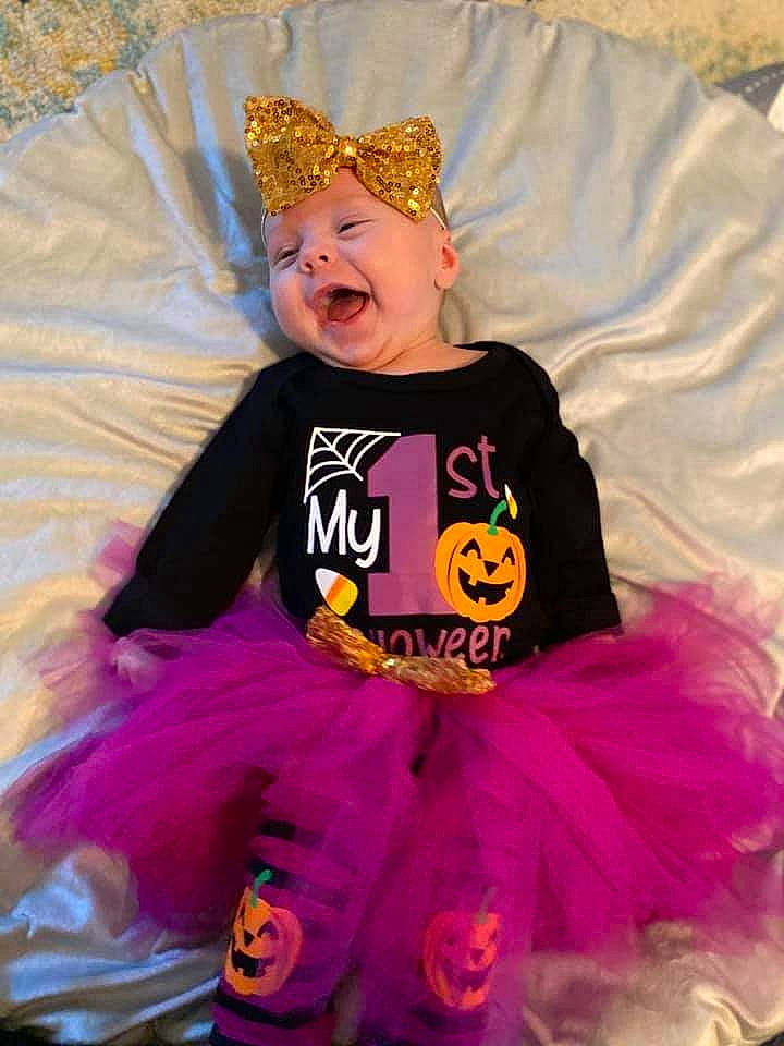 Scarlett joined the competition — help win amazing prizes! baby_toddler_clothing, child, costume, costume_accessory, costume_hat, crown, entertainment, event, fashion_accessory, fun, happy, headpiece, headwear, magenta, party_supply, performing_arts, person, pink, purple, smile