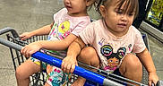 Lilly joined the competition — help win amazing prizes! children, toddlers, siblings, shopping_cart, grocery_store, supermarket, freezer_aisle, shopping, sitting, smiling, faces, girls, pink_shirts, barefoot, cart_ride, indoors, retail, food, refrigerated_cases, family