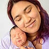 mother, newborn, baby, infant, parent, motherhood, portrait, close_up, cuddling, sleeping, peaceful, smiling, face, eyes_closed, purple_hair, lavender_clothing, hand, family, indoor, adorable