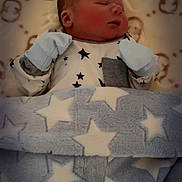 Roman is registered to the contest to win money with this photo: newborn, baby, sleeping, blanket, stars, blue, white, mittens, onesie, pattern, cozy, soft, infant, child, resting, cute, face, head, peaceful, portrait