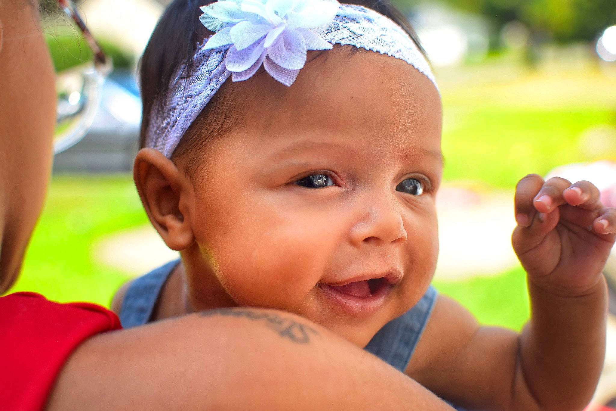 Jaylani is registered to the contest to win money with this photo: baby, child, face, fashion_accessory, finger, grass, hair_accessory, hand, happy, head, headband, headgear, headpiece, lip, person, skin, smile, summer, toddler