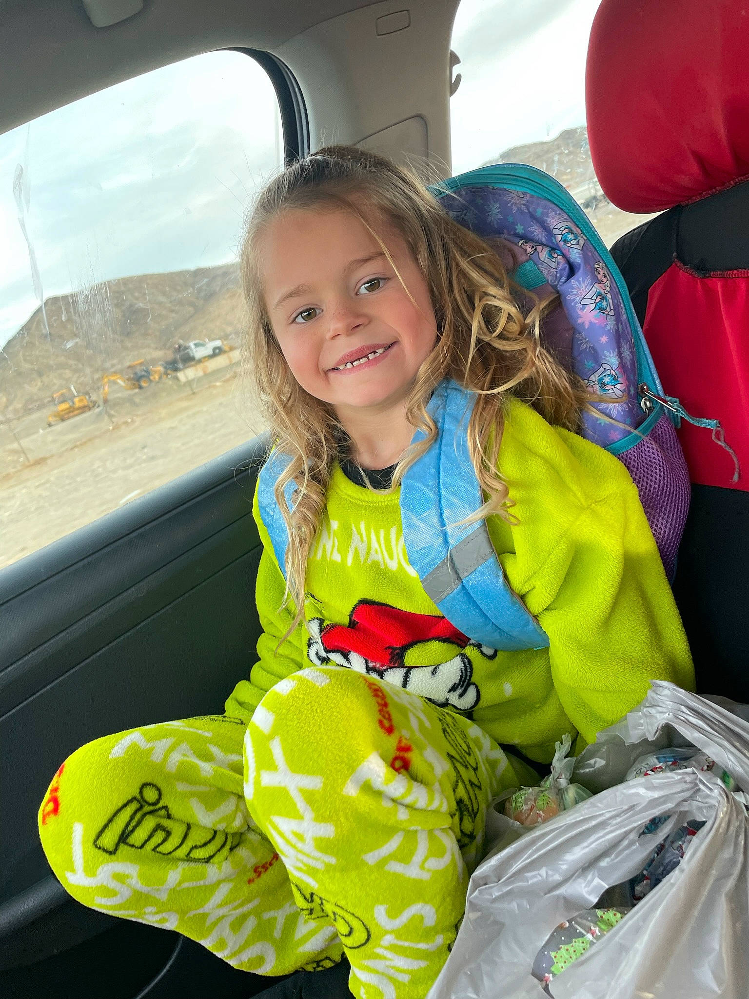 Tiffany is registered to the contest to win money with this photo: air_travel, automotive_exterior, beauty, child, cloud, event, fun, hair, happy, joy, leisure, motor_vehicle, person, plastic_bag, recreation, sitting, sky, smile, toddler, travel