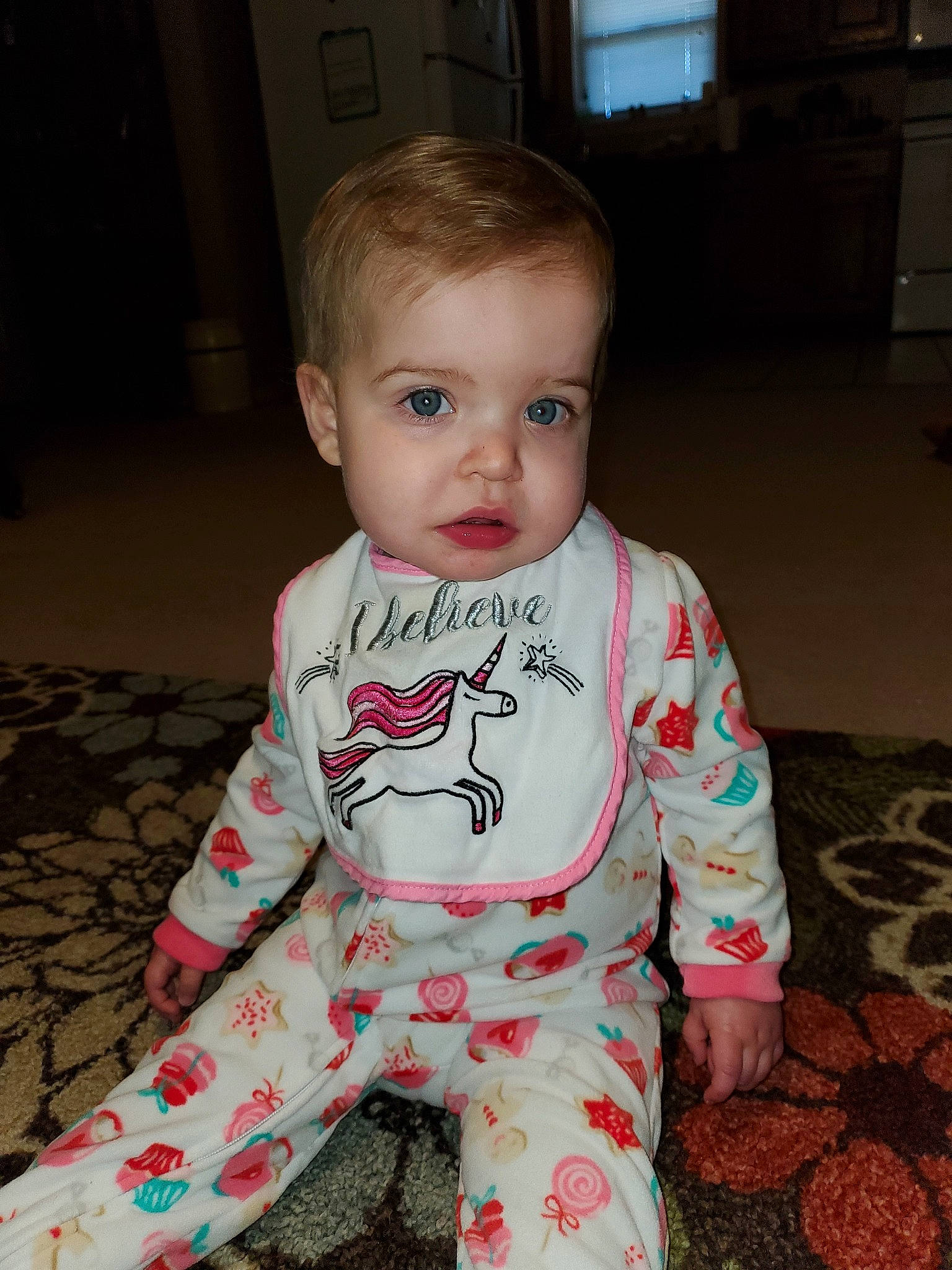 Eliana is registered to the contest to win money with this photo: baby, baby_toddler_clothing, cheek, child, eye, head, lip, pajamas, person, sitting, skin, sleeve, smile, t_shirt, toddler