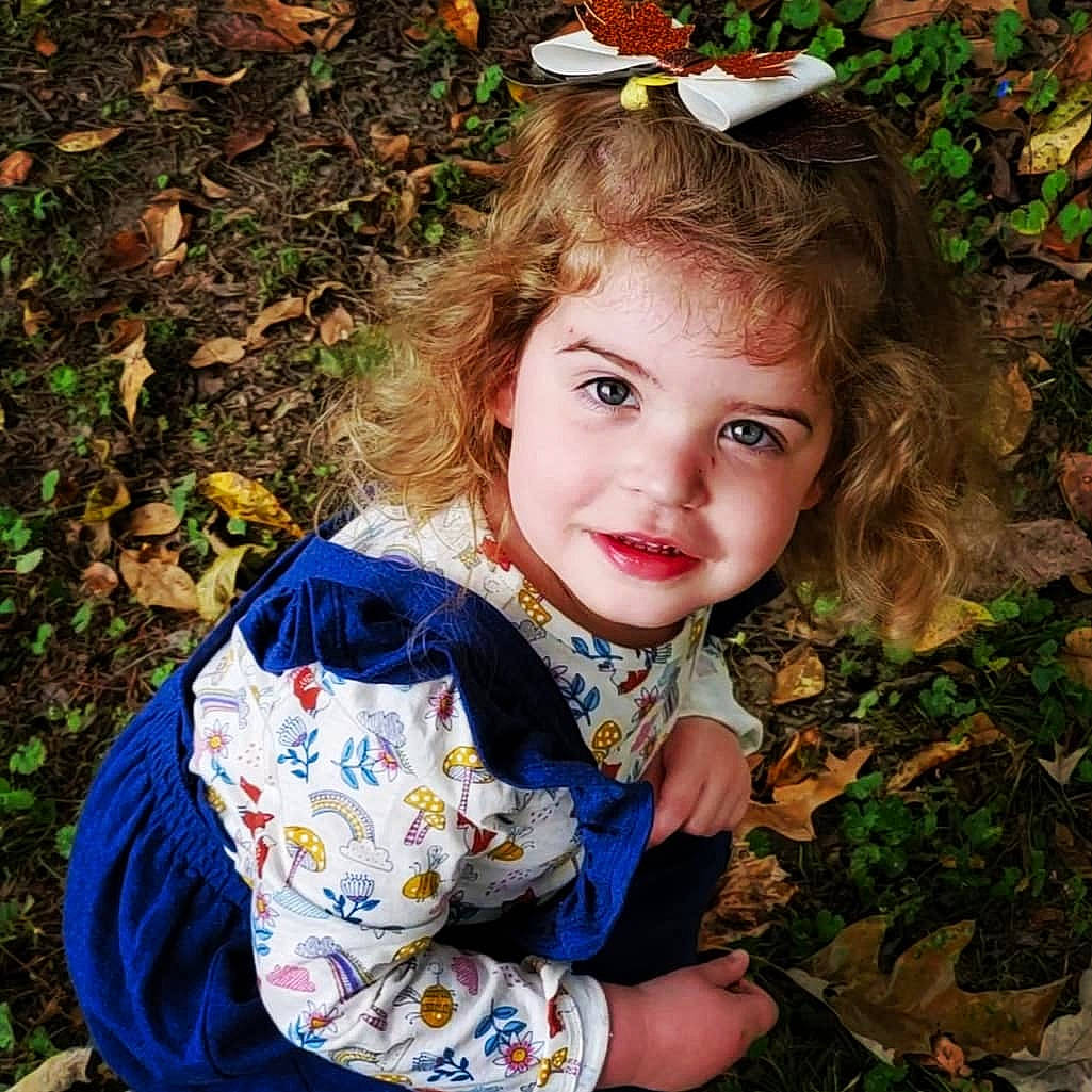 Noelle is registered to the contest to win money with this photo: baby_toddler_clothing, beauty, botany, brown_hair, child, cool, fawn, grass, hair, happy, headpiece, iris, joy, leaf, lip, people_in_nature, person, plant, sunglasses, toddler