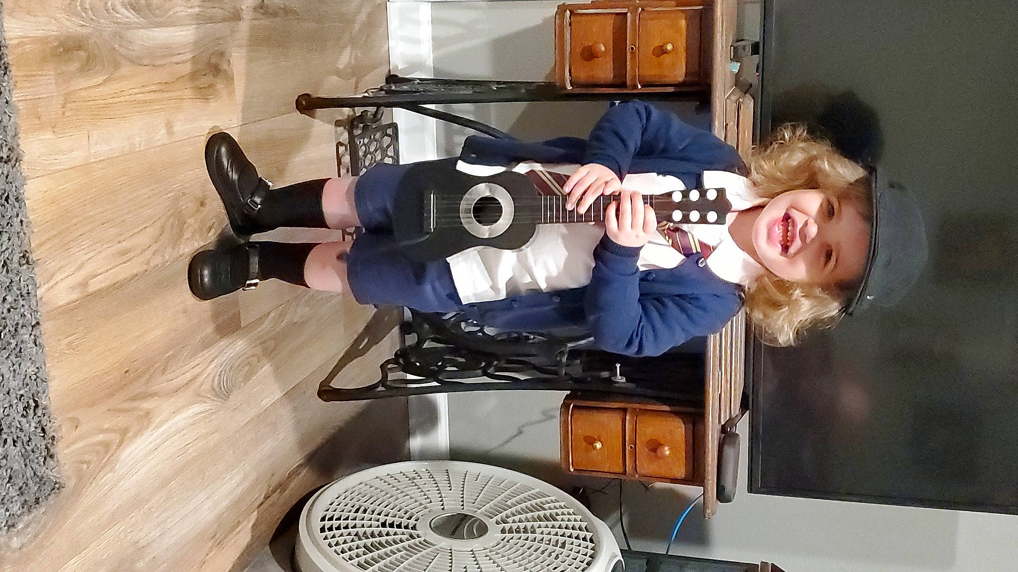 Noelle joined the competition — help win amazing prizes! audio_equipment, automotive_design, automotive_tire, automotive_wheel_system, camera_operator, electronic_instrument, guitar, hat, headwear, home_appliance, joy, machine, mechanical_fan, musical_instrument, musician, person, recreation, room, shooting, smile