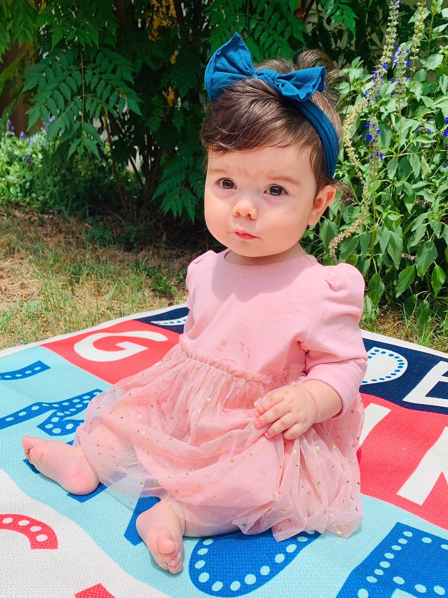 Rocket is registered to the contest to win money with this photo: baby, baby_toddler_clothing, child, child_model, clothing, costume, dress, fashion_accessory, hair_accessory, headband, headgear, pattern, person, pink, play, sitting, sleeve, textile, toddler