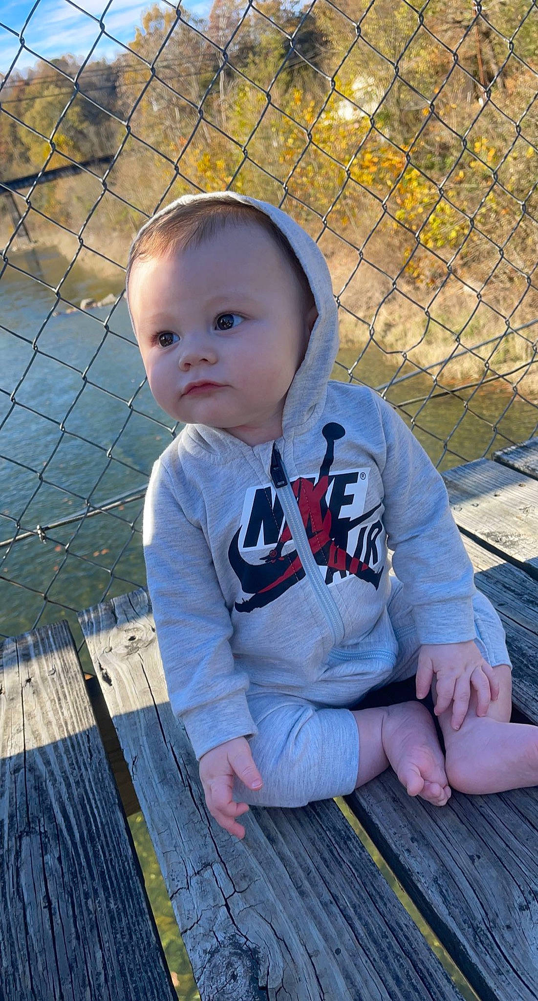 Travis joined the competition — help win amazing prizes! baby, baby_products, baby_toddler_clothing, cheek, child, electric_blue, fence, fun, grass, happy, leaf, leisure, mesh, pattern, people_in_nature, person, sitting, skin, toddler, wire_fencing