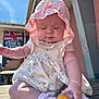 Myla-Mae joined the competition — help win amazing prizes! baby, child, sunhat, dress, sunscreen, drool, outdoor, wooden_bench, sunlight, pink, floral, cute, summer, skin_protection, closed_eyes, chubby_cheeks, socks, person, daytime, restaurant_sign