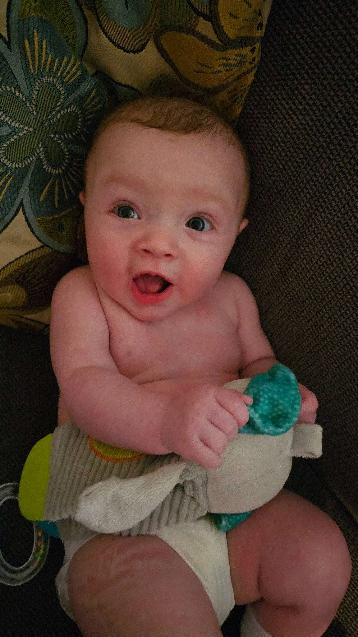 Atlas is registered to the contest to win money with this photo: arm, baby, baby_toddler_clothing, cheek, chin, eye, facial_expression, finger, head, human_body, iris, mouth, nose, organ, person, pink, skin, smile, stomach, surprise