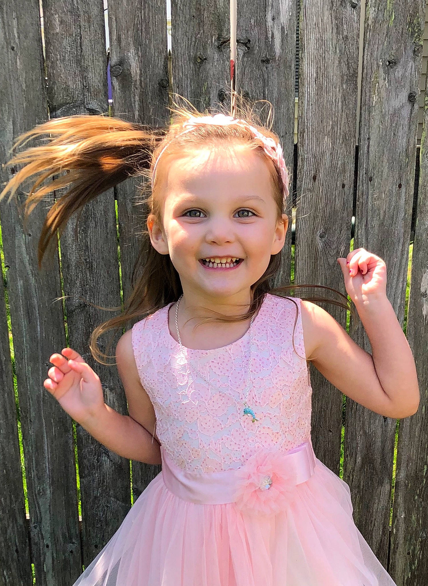 Blaire is registered to the contest to win money with this photo: baby_toddler_clothing, dress, face, finger, flash_photography, gesture, grass, hair, hairstyle, hand, happy, iris, joy, leaf, lip, people_in_nature, person, pink, shoulder, skin