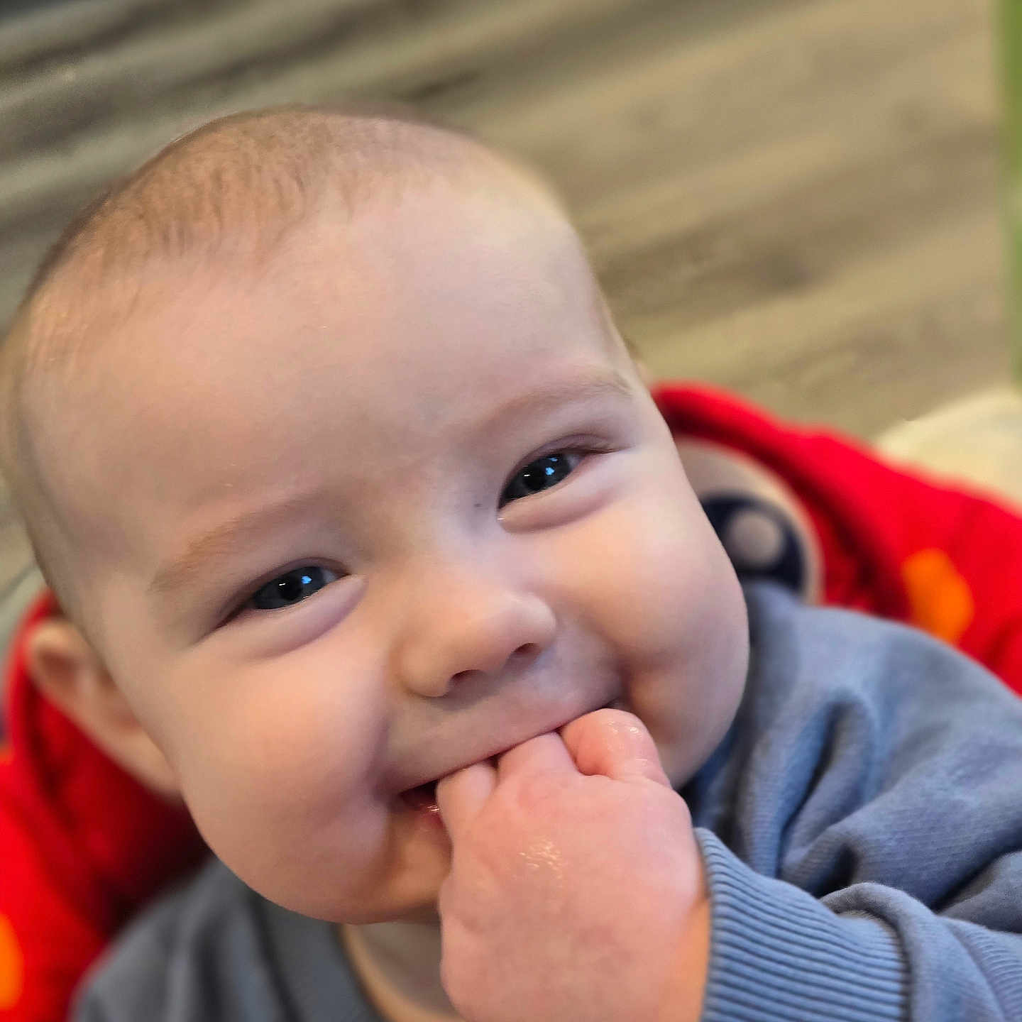 Cillian is registered to the contest to win money with this photo: baby, blue_clothing, cheeks, child, closeup, cute, expression, face, fingers, hand, happy, indoors, infant, person, portrait, sitting, skin, smile, young_baby, young_child