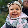 baby, child, smile, happy, face, hat, beanie, ears, jacket, fleece, pink, gray, pattern, leaf, person, adult, beard, outdoor, blurred_background, closeup