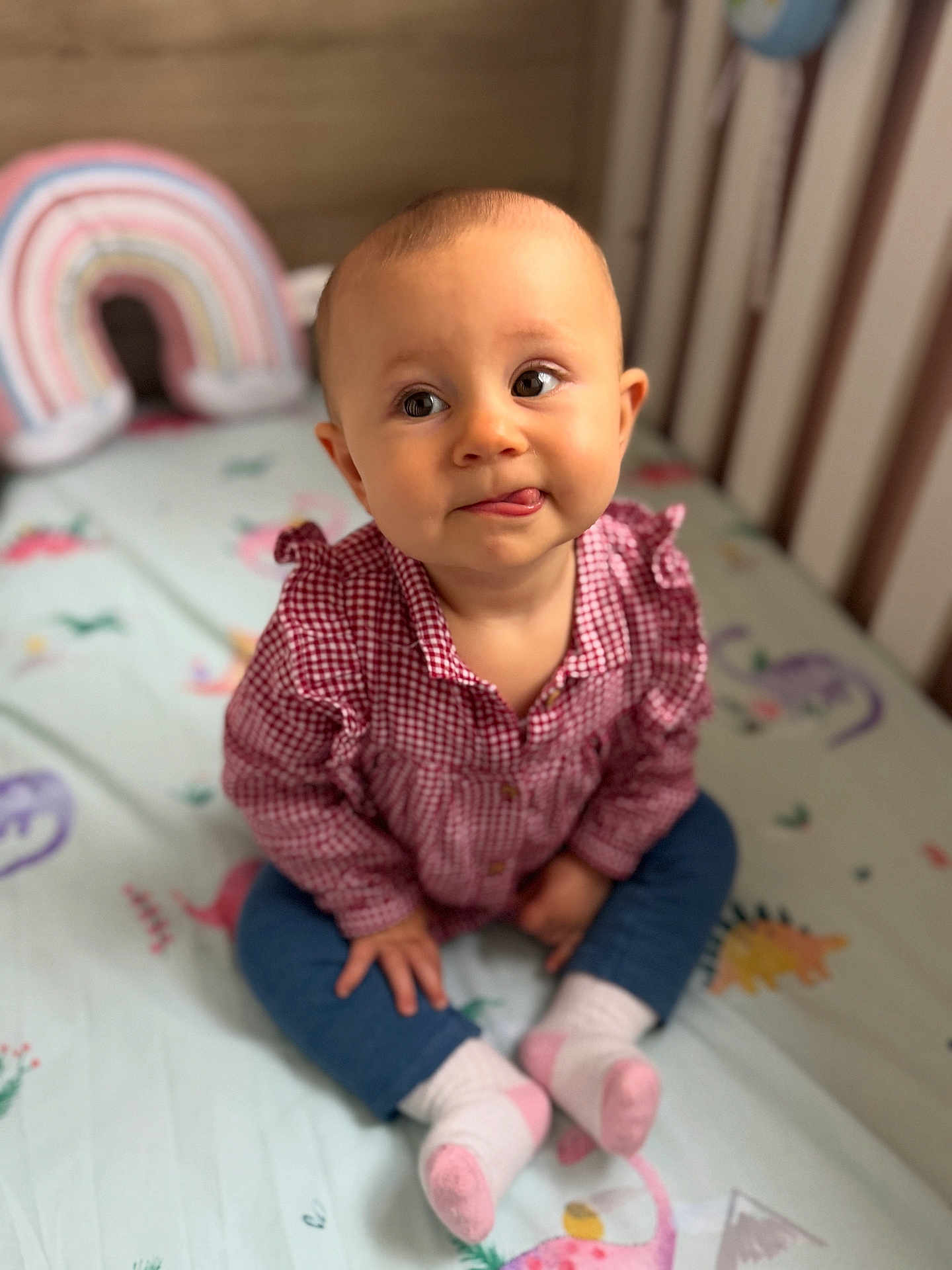 Nicole is registered to the contest to win money with this photo: baby, child, infant, crib, bed, bedding, clothing, shirt, pants, socks, tongue, face, eyes, hands, sitting, indoor, cute, playful, colorful, toy