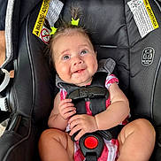 Ivory joined the competition — help win amazing prizes! baby, child, car_seat, safety_harness, smiling, cute, infant, pigtails, hair_clips, red_and_white_clothing, happy, seat_belt, indoor, person, closeup, portrait, young_child, skin, face, expression