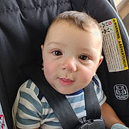 Trenton joined the competition — help win amazing prizes! baby, child, car_seat, striped_shirt, harness, face, eyes, smile, infant, sitting, safety, seatbelt, cute, portrait, indoors, young_child, soft_light, closeup, person, clothing