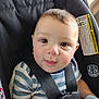 baby, child, car_seat, striped_shirt, harness, face, eyes, smile, infant, sitting, safety, seatbelt, cute, portrait, indoors, young_child, soft_light, closeup, person, clothing