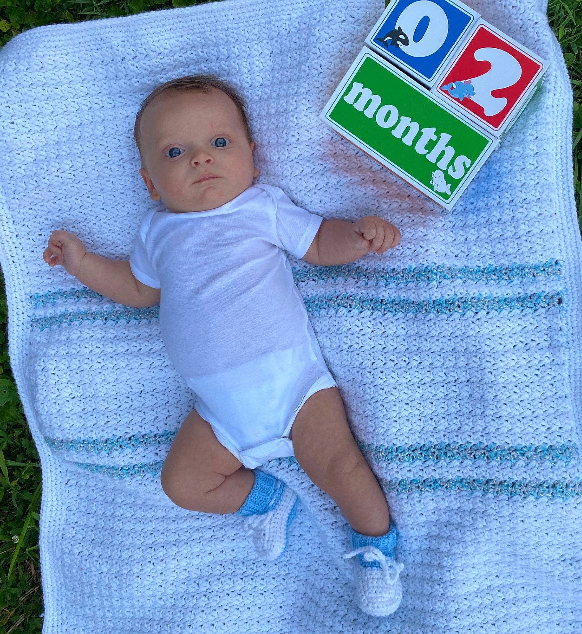 Easton joined the competition — help win amazing prizes! aqua, azure, baby, baby_products, baby_toddler_clothing, child, electric_blue, finger, infant_bodysuit, linens, pattern, person, product, sitting, sleeve, sock, sportswear, t_shirt, textile, thigh