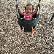 Nalani joined the competition — help win amazing prizes! baby, child, cute, daylight, feet, fun, grass, hands, happy, infant, metal_chains, outdoor, person, pink_clothing, playground, seat, smiling, summer, swing, woodchips