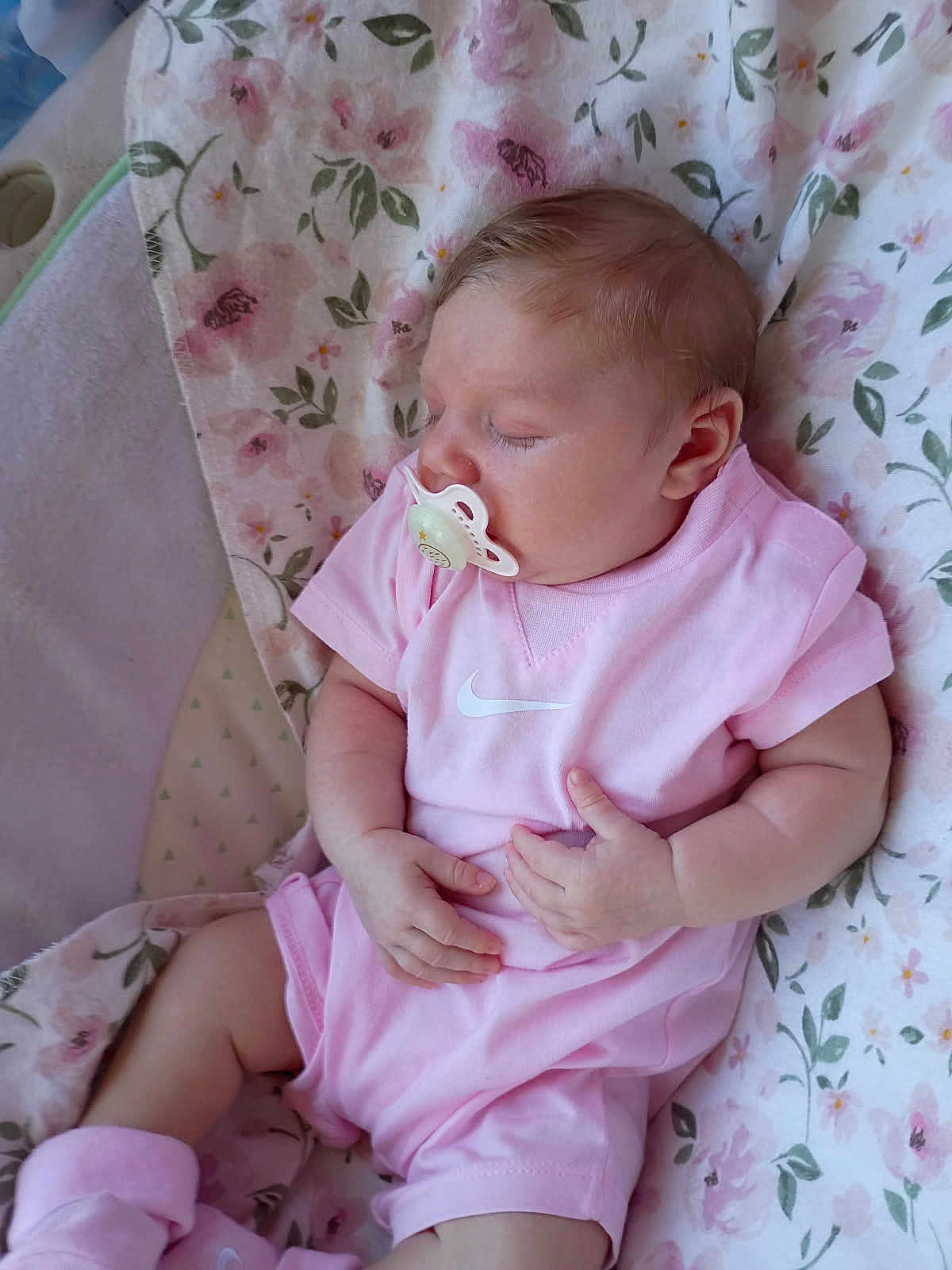 Lilyannah joined the competition — help win amazing prizes! baby, pacifier, sleeping, pink_clothing, blanket, floral, infant, cute, soft, peaceful, child, apparel, head, hand, footwear, indoors, resting, young, person, cozy