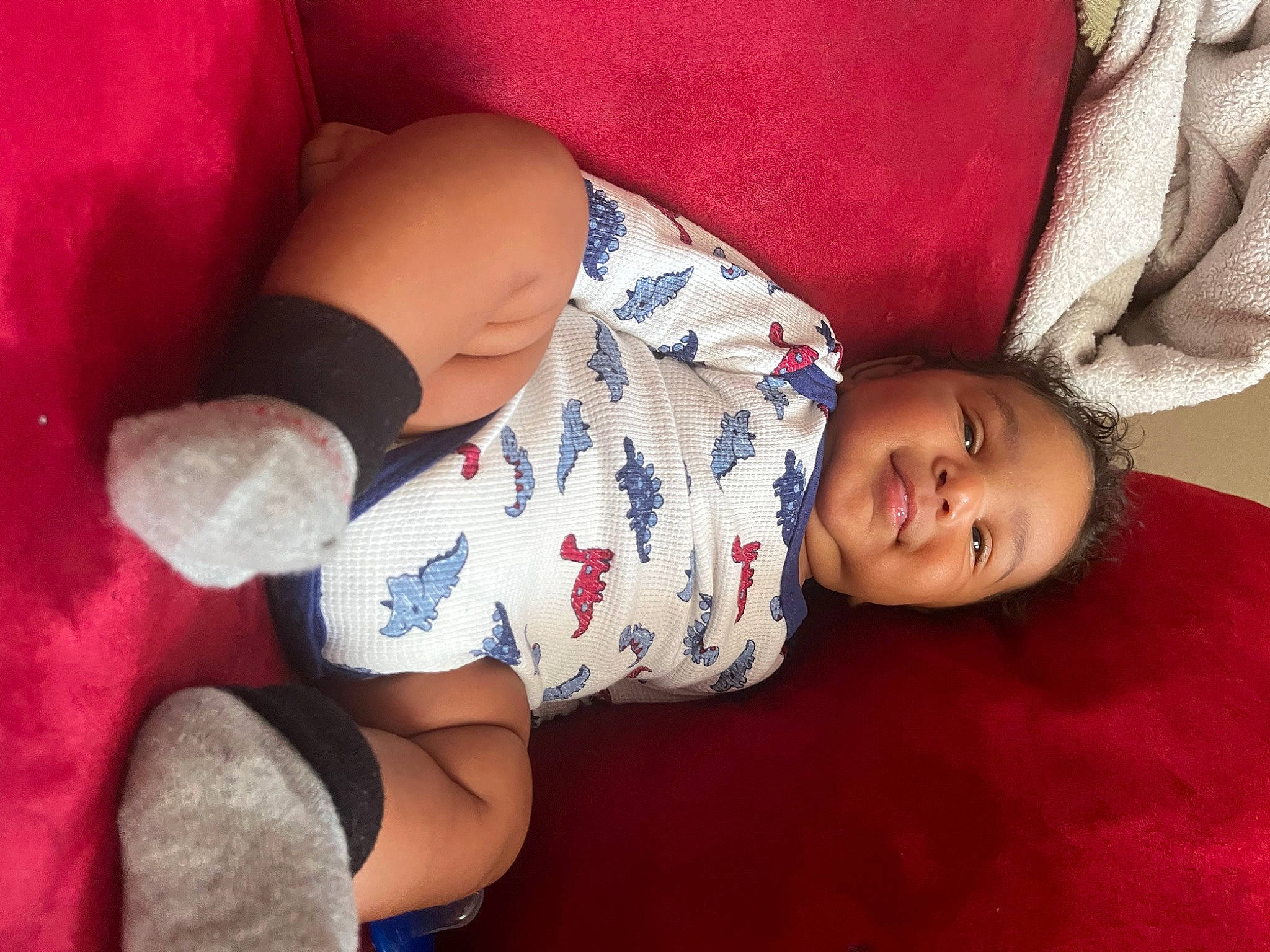 Leonidas is registered to the contest to win money with this photo: arm, baby_toddler_clothing, comfort, couch, eye, face, finger, hand, head, human_body, joint, knee, leg, mammal, mouth, muscle, person, skin, textile, thigh
