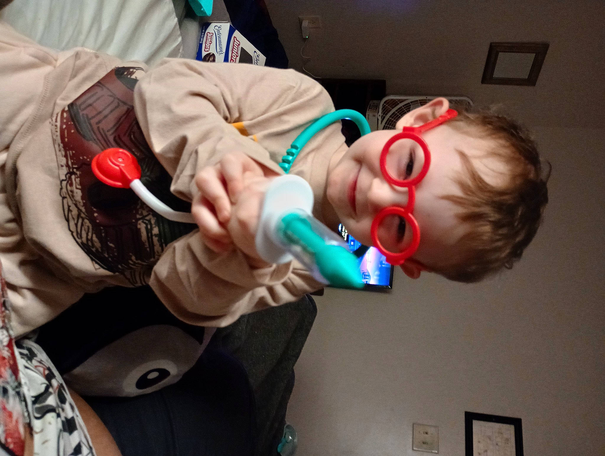 Jesiah is registered to the contest to win money with this photo: audio_equipment, child, costume, elbow, event, eyelash, eyewear, fun, gesture, happy, jaw, joy, mouth, nail, person, personal_protective_equipment, room, smile, t_shirt, tattoo