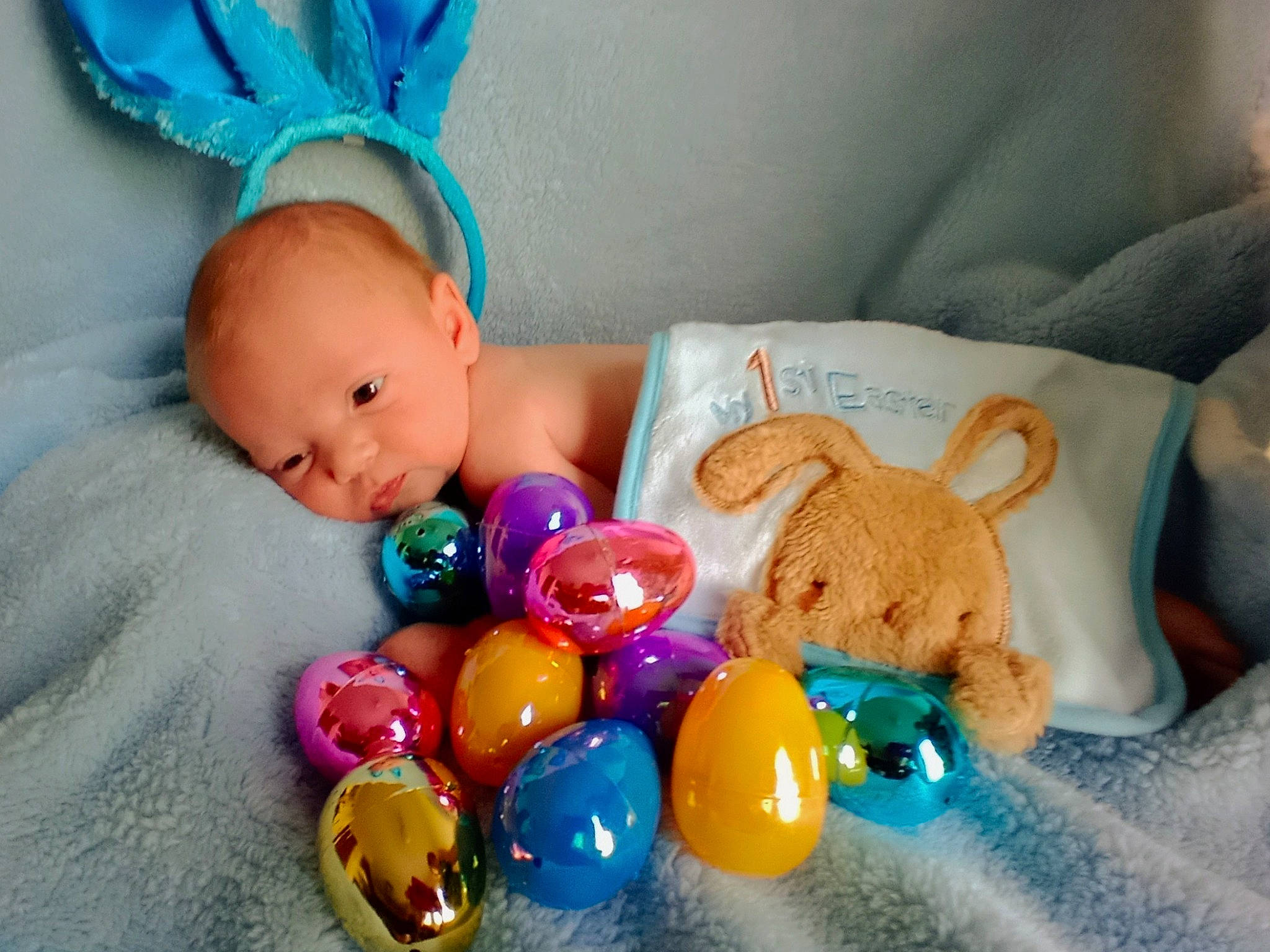 Jesiah is registered to the contest to win money with this photo: azure, baby, baby_products, baby_sleeping, baby_toddler_clothing, baby_toys, blue, child, comfort, fashion_accessory, happy, head, linens, person, product, room, skin, textile, toddler, toy