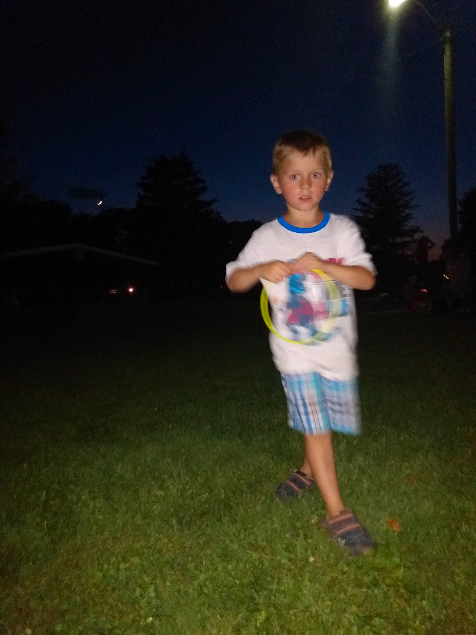 Dallas is registered to the contest to win money with this photo: child, fun, grass, night, person, photography, recreation, sky, smile, sparkler, standing, summer, toddler, tree, vacation
