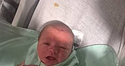 Graysun is registered to the contest to win money with this photo: newborn, baby, infant, hospital, bassinet, blanket, mint_green, sleeping, face, hand, wristband, medical, bed, portrait, indoor, patient, swaddled, resting, adult_arm, photobomb