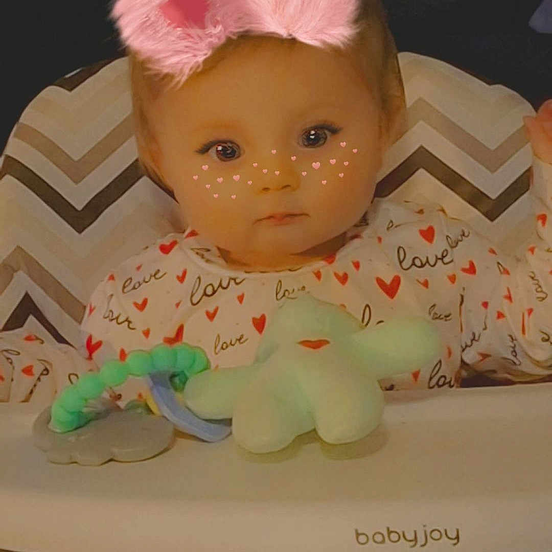 River joined the competition — help win amazing prizes! baby, high_chair, pajamas, hearts, love, face_filter, pink_bunny_ears, freckles, toy, babyjoy, child, infant, cute, indoor, portrait, seated, playful, expression, young, adorable
