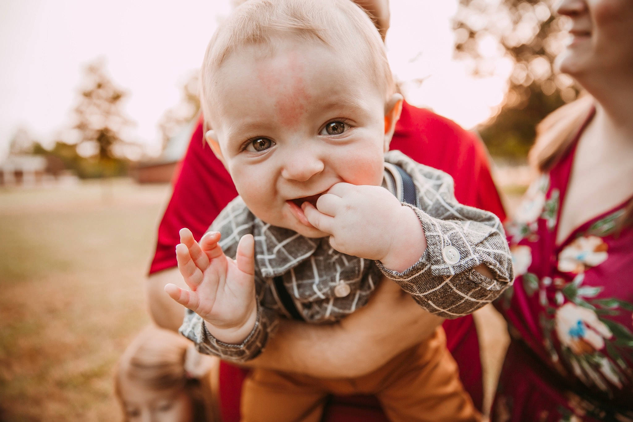 Tommy is registered to the contest to win money with this photo: baby, baby_toddler_clothing, child, finger, fun, gesture, grass, hand, happy, laugh, nail, pattern, people_in_nature, person, plant, reptile, skin, smile, terrestrial_animal, thumb