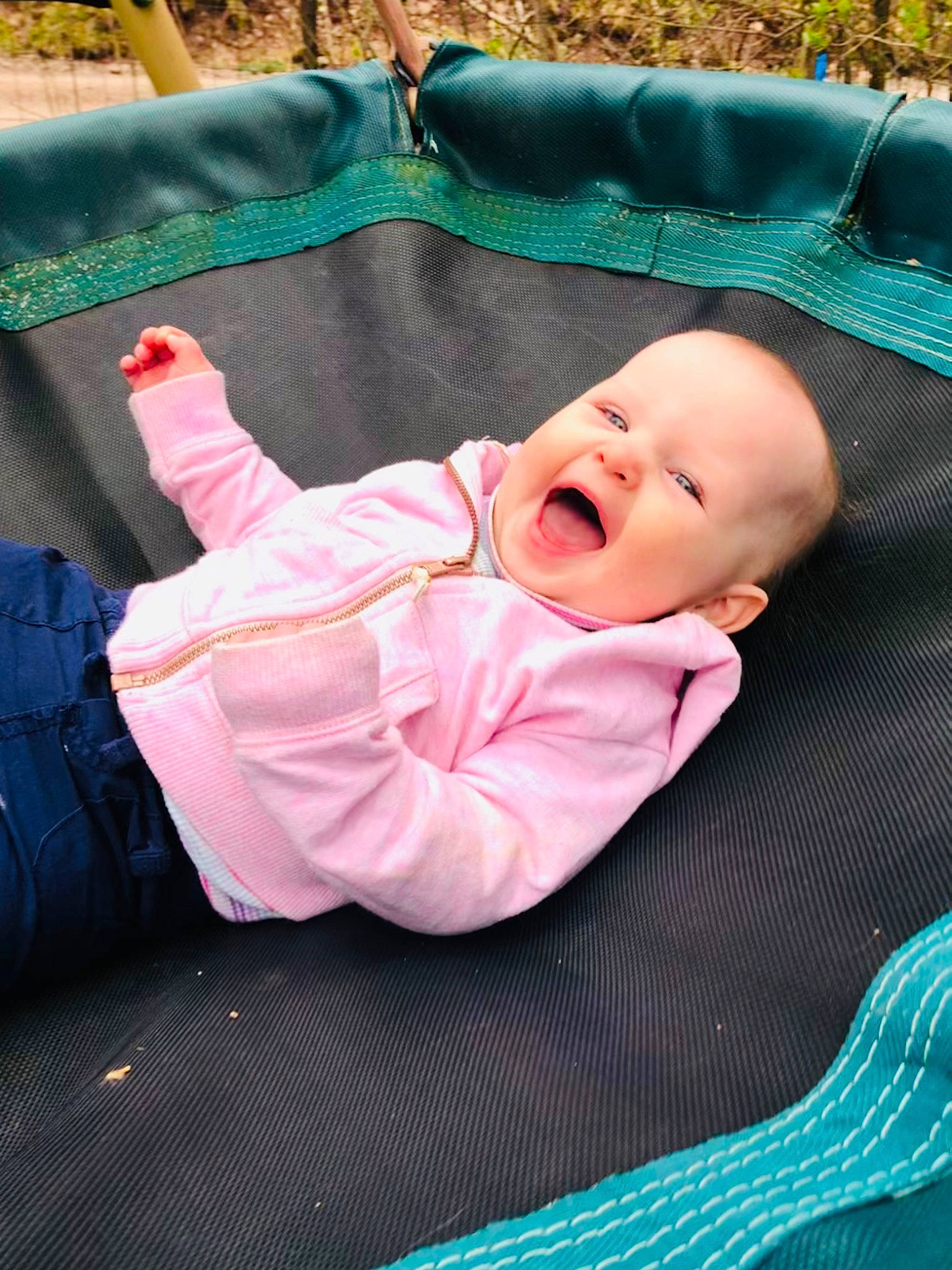 Caroline is registered to the contest to win money with this photo: baby, baby_products, baby_toddler_clothing, backpack, bag, child, comfort, fun, grass, happy, head, human_body, leisure, linens, luggage_and_bags, person, recreation, sitting, smile, toddler