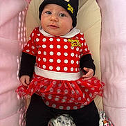 Cléo participe au concours pour gagner de l'argent avec cette photo : baby, infant, child, minnie_mouse, hat, costume, red_dress, polka_dots, tutu, black_leggings, yellow_booties, pink_cushion, blanket, cute, portrait, indoors, smiling, face, person, seated