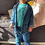 toddler, child, smiling, denim_jacket, denim_pants, socks, living_room, couch, blanket, carpet, happy, indoor, person, clothing, casual, portrait, cute, young_child, standing, home