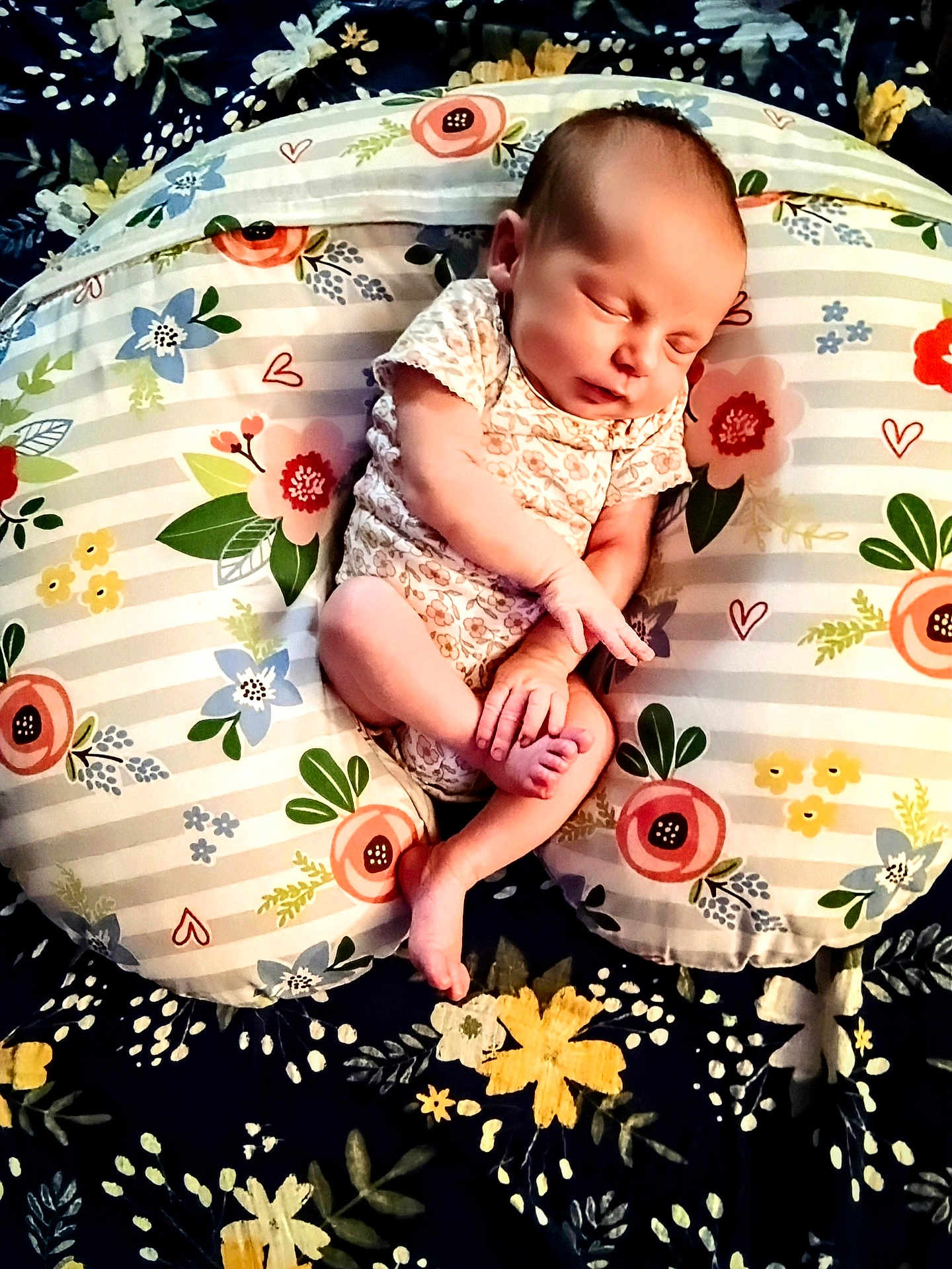 Bellefyre is registered to the contest to win money with this photo: baby, newborn, sleeping, infant, cushion, floral_pattern, blanket, hand, foot, onesie, peaceful, cozy, bedroom, soft, resting, cute, comfort, child, portrait, indoor