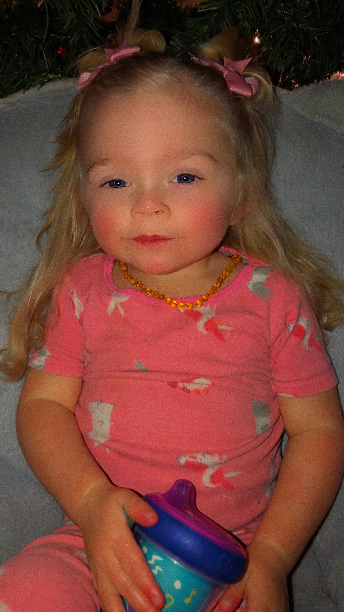 Frankie is registered to the contest to win money with this photo: baby_toddler_clothing, blond, cheek, child, communication_device, eyelash, gadget, grass, happy, head, iris, jewellery, lip, magenta, nose, person, pink, sitting, skin, t_shirt