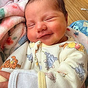 Kimber joined the competition — help win amazing prizes! baby, newborn, smiling, sleeping, blanket, onesie, cartoon_characters, infant, cute, cozy, indoor, child, portrait, soft_lighting, happy, peaceful, small_hands, clothing, face, skin