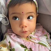 Devyani is registered to the contest to win money with this photo: adorable, apparel, baby, child, closeup, clothing, cute, expression, face, floral, headband, indoors, infant, looking_away, person, pink, portrait, ruffles, skin, young_child