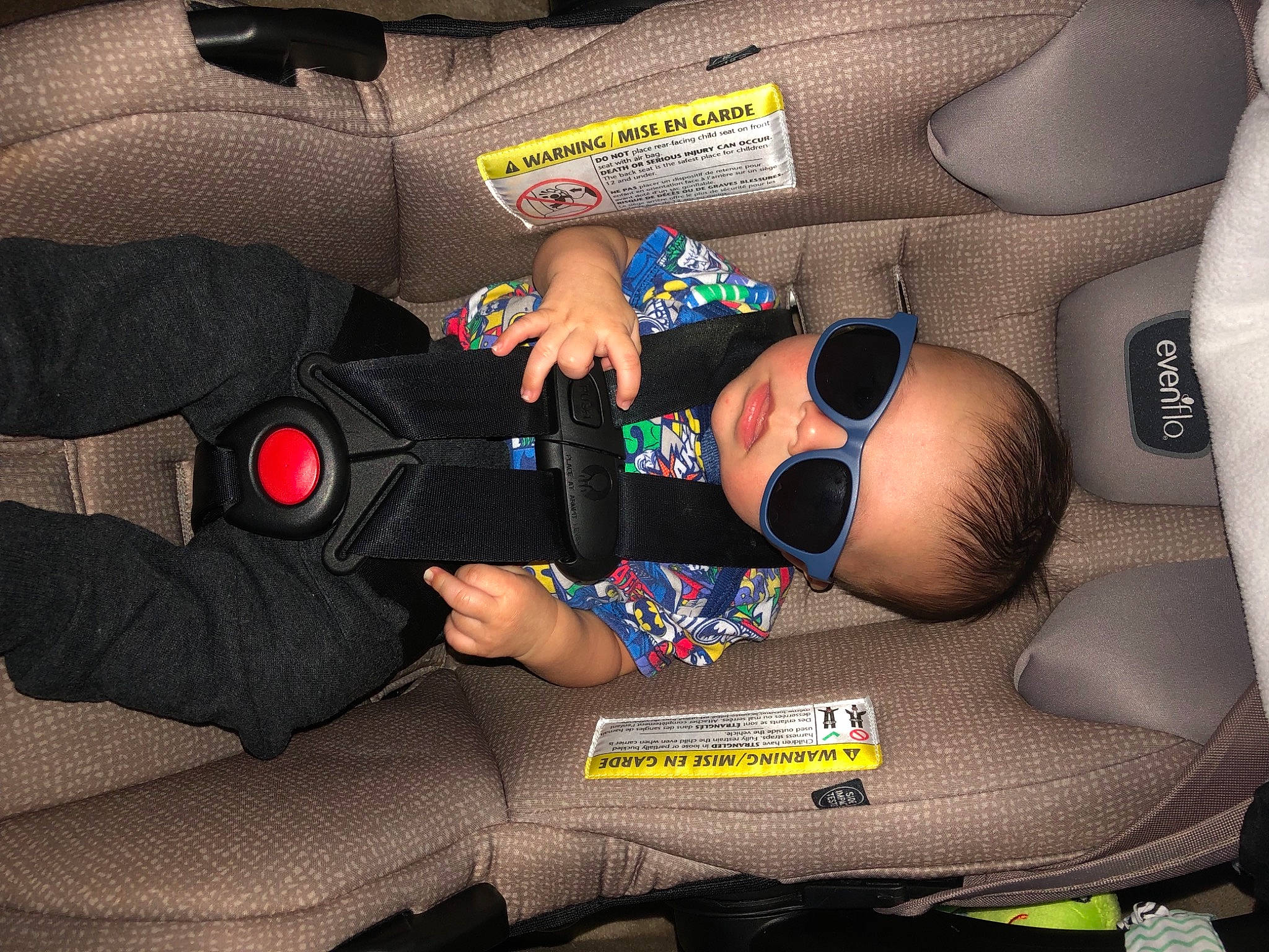 Paxton is registered to the contest to win money with this photo: arm, auto_part, automotive_design, automotive_wheel_system, baby_products, car_seat, child, comfort, elbow, finger, human_leg, joint, knee, lap, motor_vehicle, person, product, service, thigh, vehicle