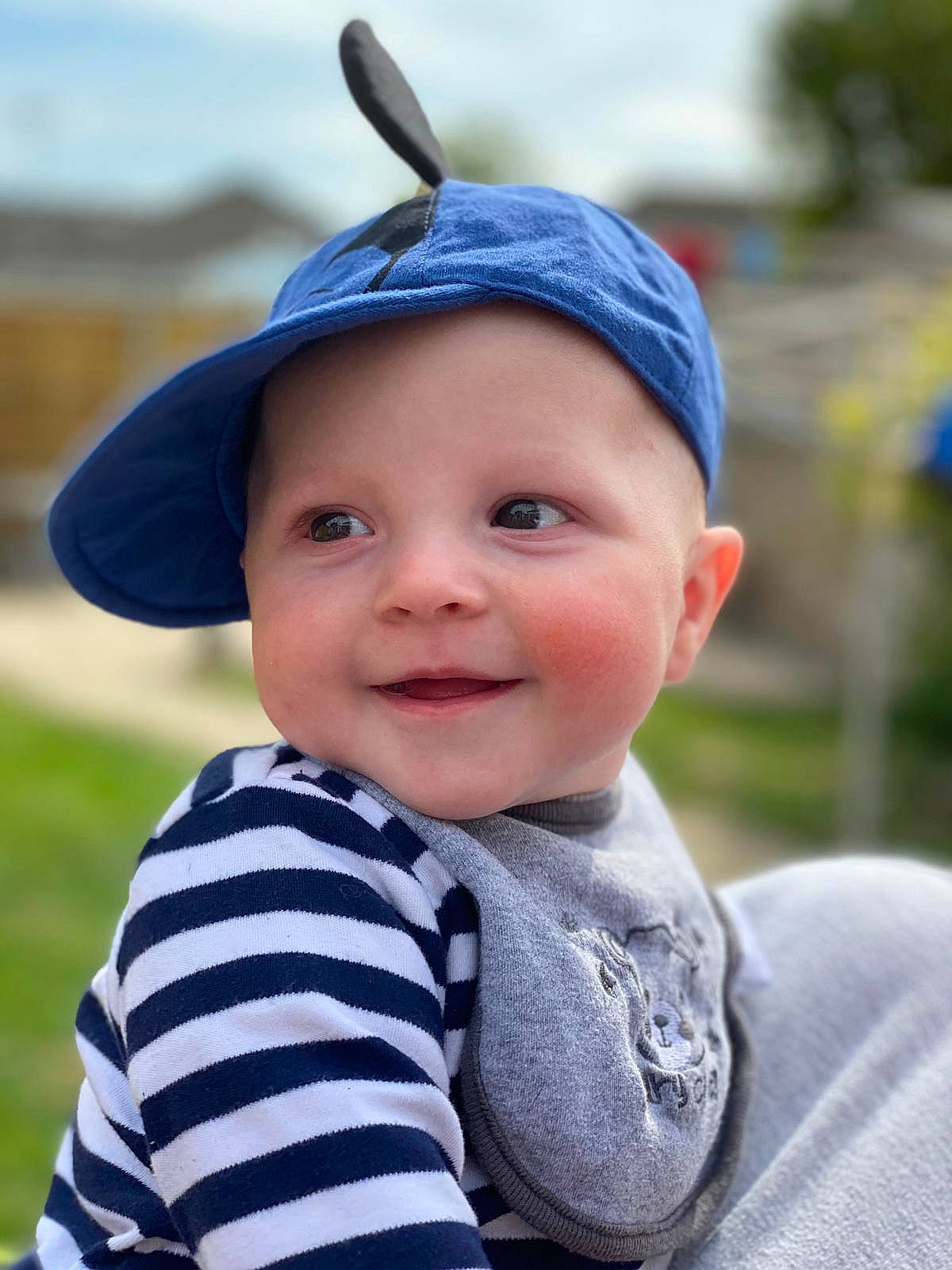 Mickey is registered to the contest to win money with this photo: baby, cap, child, ear, face, fashion_accessory, hat, head, headgear, headwear, joy, people, person, photography, skin, smile, sun_hat, toddler, vacation
