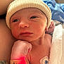 newborn, baby, infant, hat, hospital, medical_sensor, wrapped, towel, skin, face, hand, wristband, red_light, closeup, person, sleepy, cute, healthcare, newborn_baby, patient