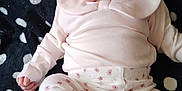 Carlina is registered to the contest to win money with this photo: baby, infant, child, pink_clothing, floral_headband, polka_dot_blanket, white_dots, soft_fabric, cute, portrait, smiling, barefoot, sitting, indoors, closeup, happy, relaxed, small_hand, small_foot, casual