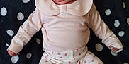 Carlina is registered to the contest to win money with this photo: baby, infant, child, pink_clothing, hat, headwear, patterned_pants, floral, blanket, dots, cute, portrait, lying_down, small_hands, soft_fabric, white, black, looking_away, indoors, newborn