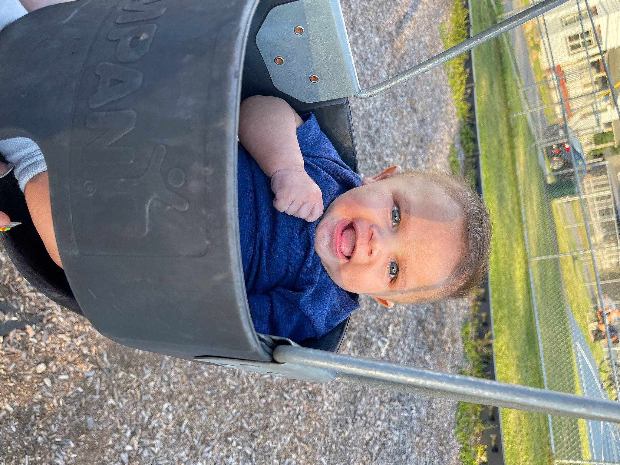 Camdyn is registered to the contest to win money with this photo: auto_part, automotive_exterior, automotive_tire, automotive_wheel_system, bumper, child, city, electric_blue, fun, hat, leisure, outdoor_play_equipment, person, playground, public_space, recreation, smile, synthetic_rubber, toddler, tree