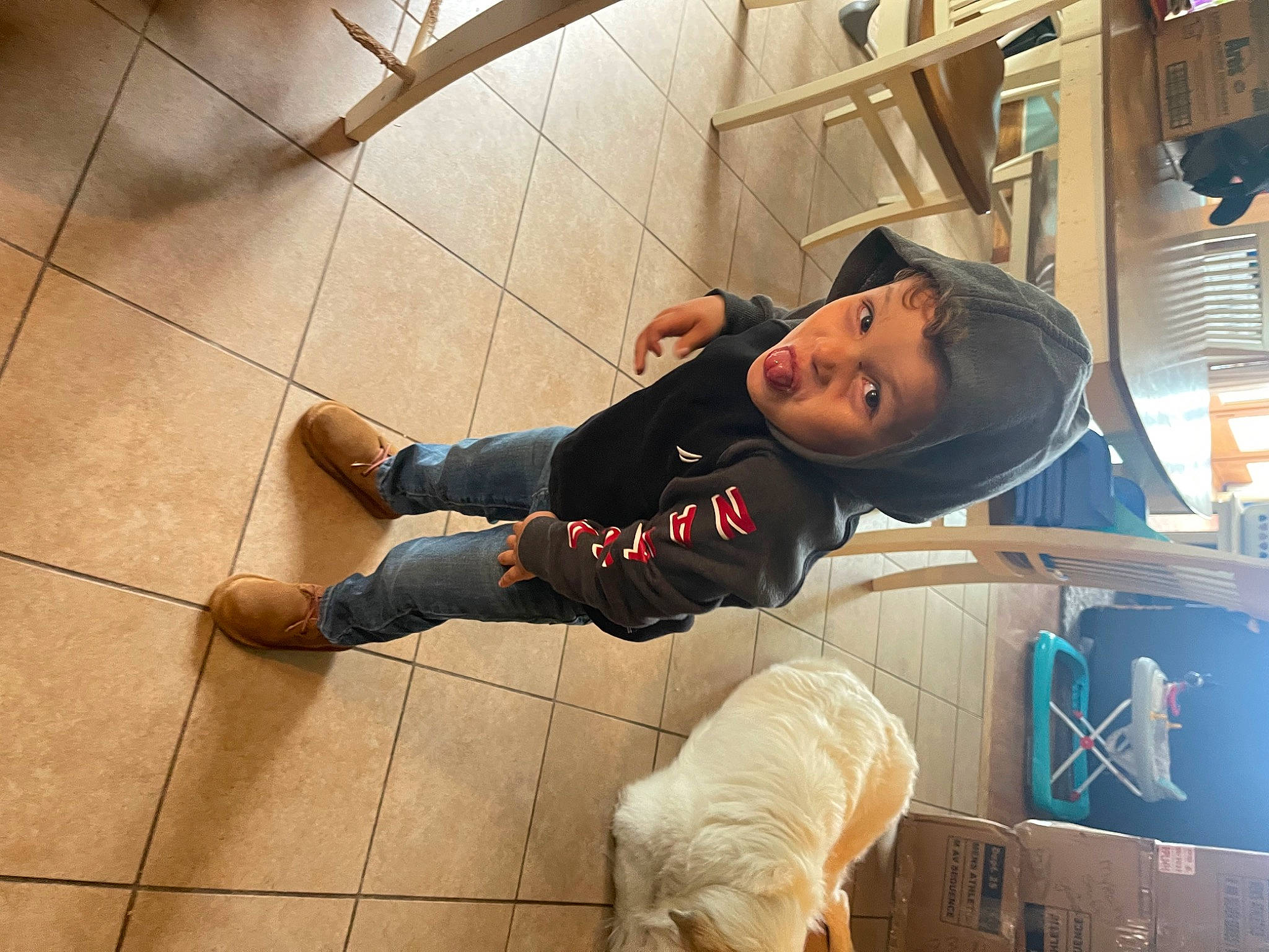 Mason joined the competition — help win amazing prizes! cap, child, denim, flooring, fun, fur, hardwood, hat, headwear, human_leg, knee, leg, leisure, person, sandal, shoe, sitting, sneakers, sportswear, t_shirt